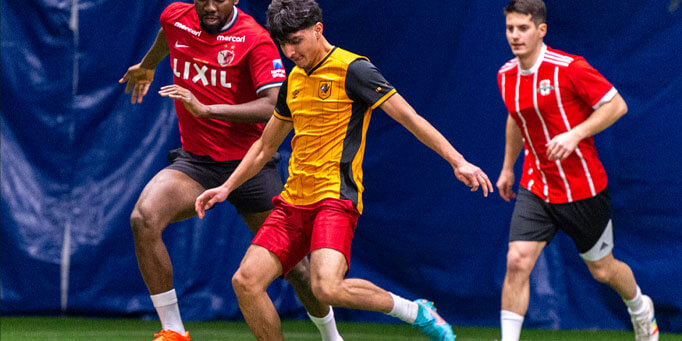 Friday men's indoor soccer league match in Mississauga at Applewood with players competing for the ball