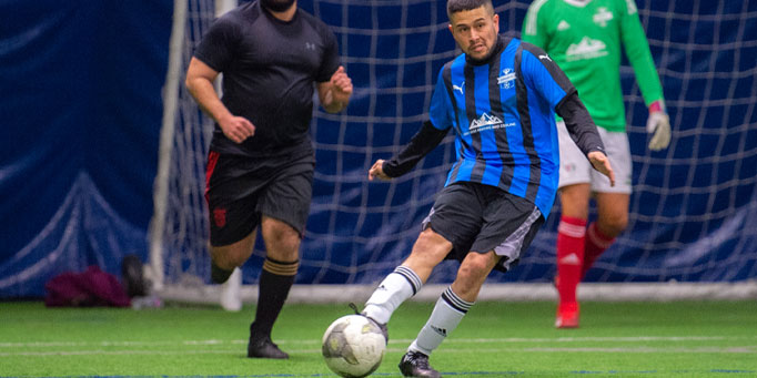 Friday men's indoor soccer league in Mississauga at Erindale with players in action on the field