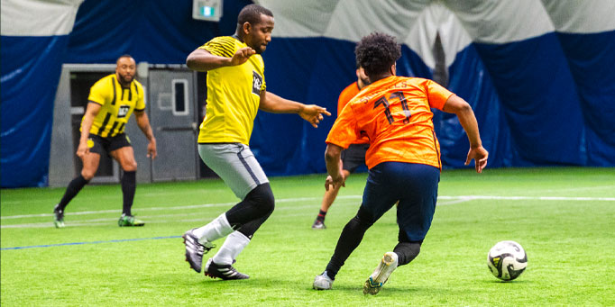 Monday men's indoor soccer league in Mississauga at Applewood with players competing during a match