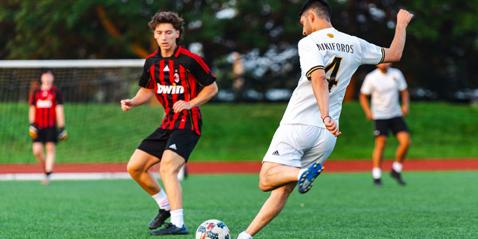 Sunday men's indoor soccer league in Mississauga at Erindale with players competing near goal