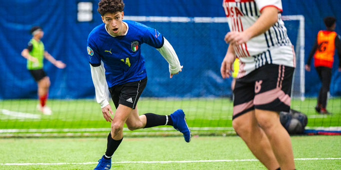 Thursday men's indoor soccer league in Mississauga at Erindale with players contesting possession