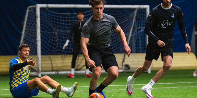 Tuesday men's indoor soccer league in Mississauga at Lakeshore Collegiate with goalkeeper and players in action