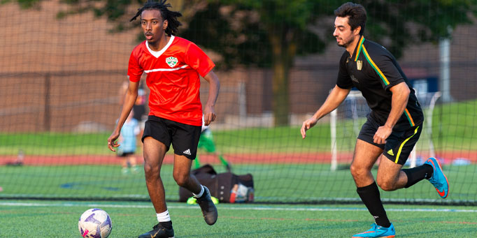 Wednesday men's indoor soccer league in Mississauga at Erindale with players challenging for the ball
